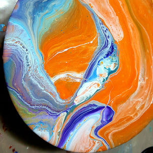 epoxy resin painting by resin artist Jane Biven. Orange purple white and blue ecopoxy resin on round structure 